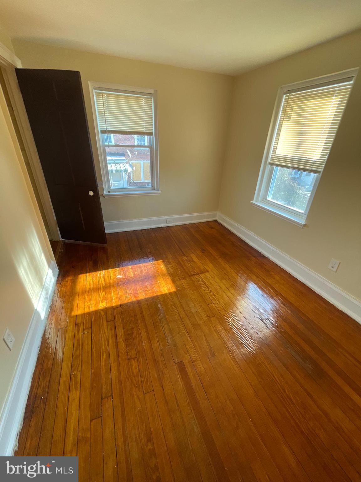 1344 Argus Road Camden, NJ 08104 - Photo 7 of 10 a view of an empty room with wooden floor and a window