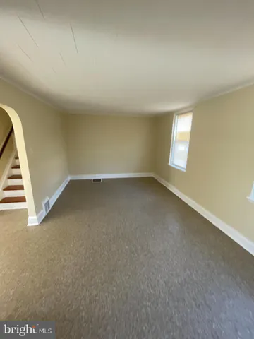 a view of an empty room with stairs