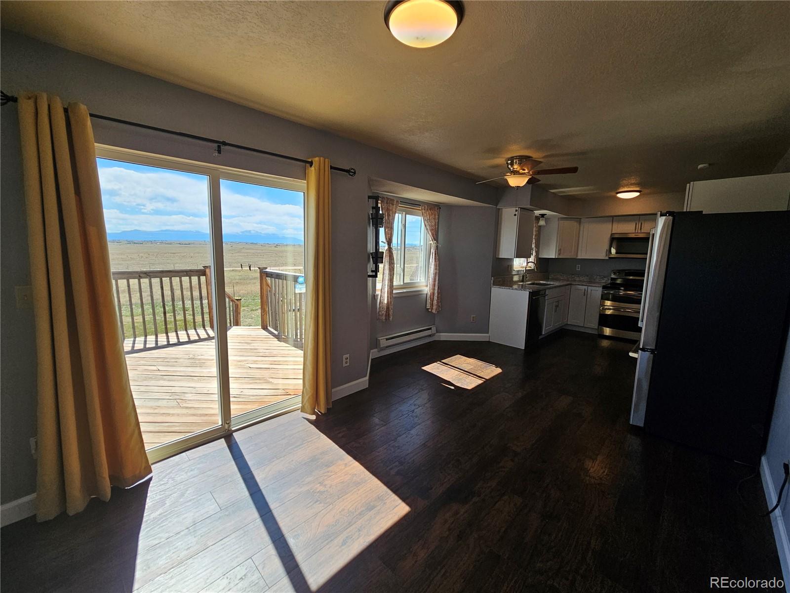 16985 Sage Crest Road Peyton, CO 80831 - Photo 7 of 25 a view of livingroom with furniture and a floor to ceiling window