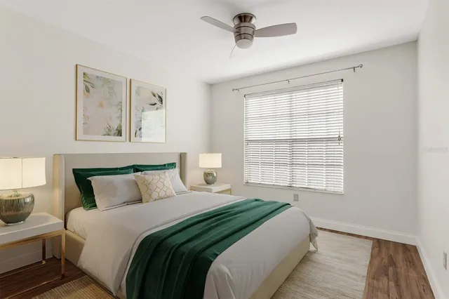 a bedroom with a large bed and a window