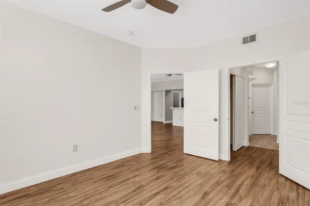 a view of an empty room and wooden floor