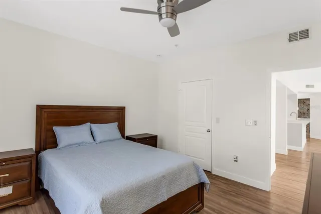 a bedroom with a bed and wooden floor