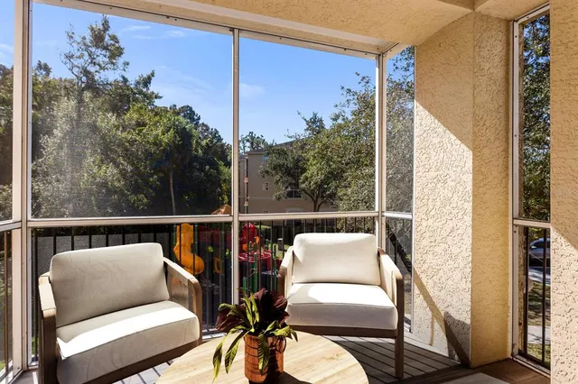 a balcony with wooden floor and outdoor seating
