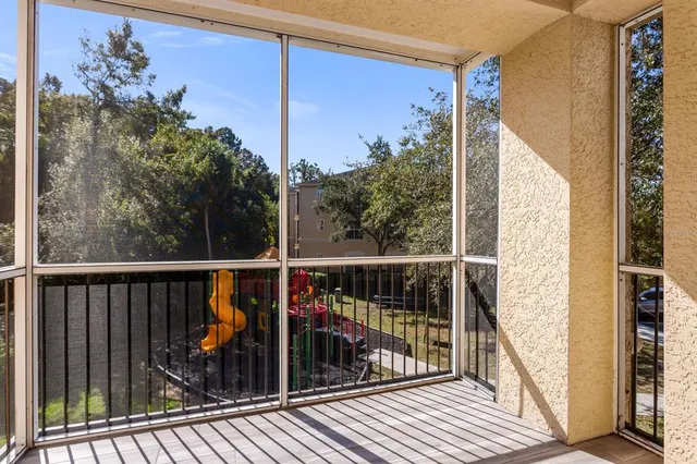 a view of a balcony with wooden floor and fence
