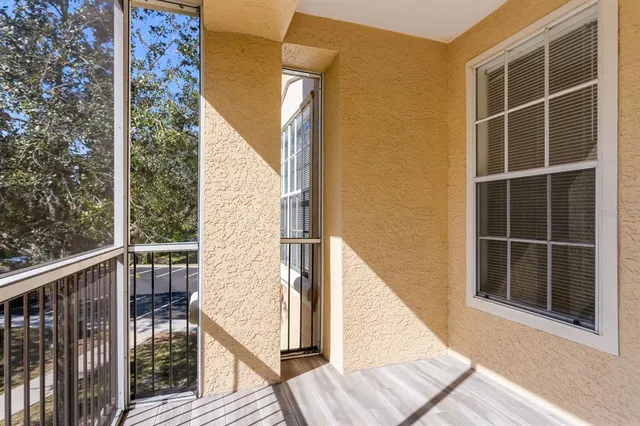 a view of balcony with wooden floor and fence