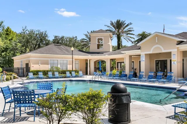 a front view of a house with swimming pool and glass windows