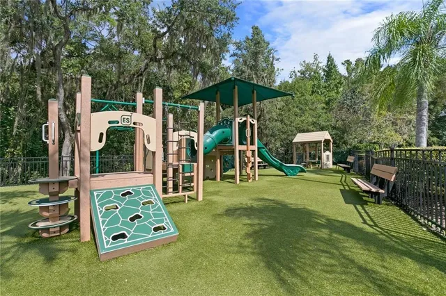 a backyard of a house with barbeque oven table and chairs