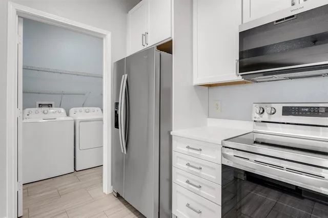 a view of a kitchen with washer and dryer