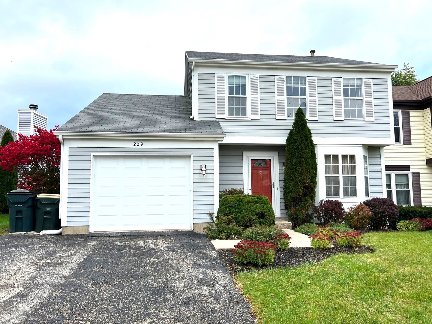 209 North Southport Road Mundelein, IL 60060 - Photo 1 of 18 a front view of a house with a yard and garage