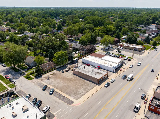 an aerial view of a residential houses with yard