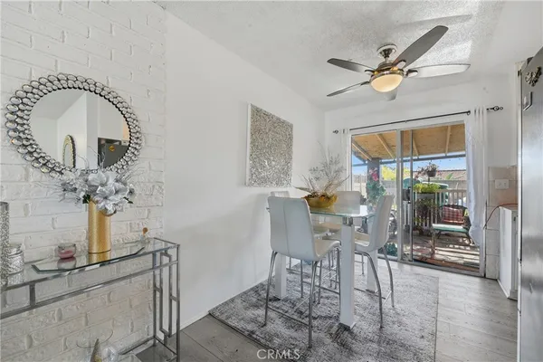 a view of a dining room with furniture and a chandelier