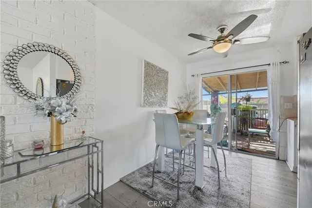 a view of a dining room with furniture and a chandelier