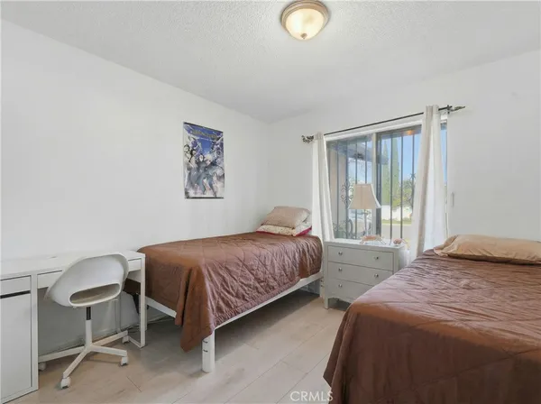 a bedroom with a bed lamp and a window