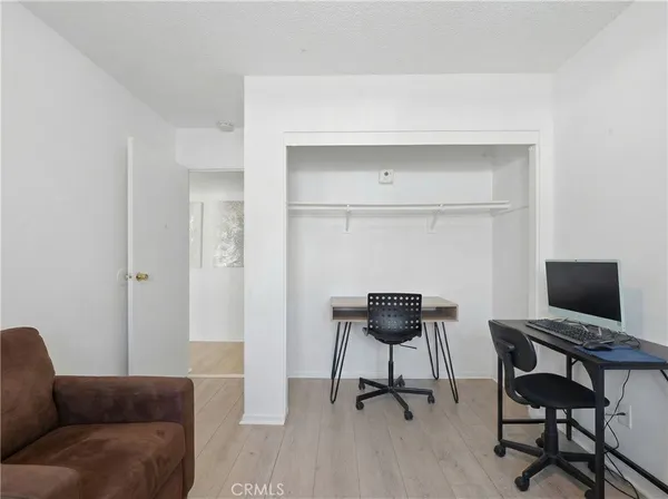 a view of a livingroom with furniture and a workspace