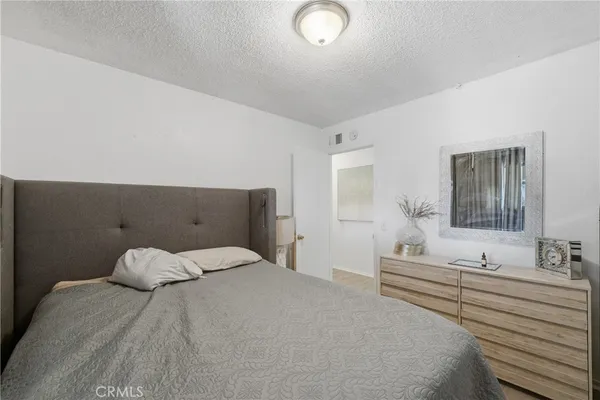 a bedroom with a bed and a mirror