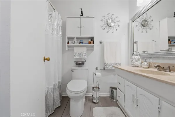 a bathroom with a toilet sink a shower and a mirror