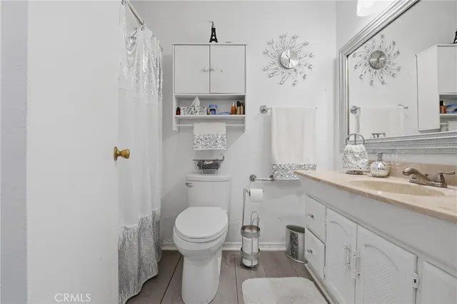 a bathroom with a toilet sink a shower and a mirror