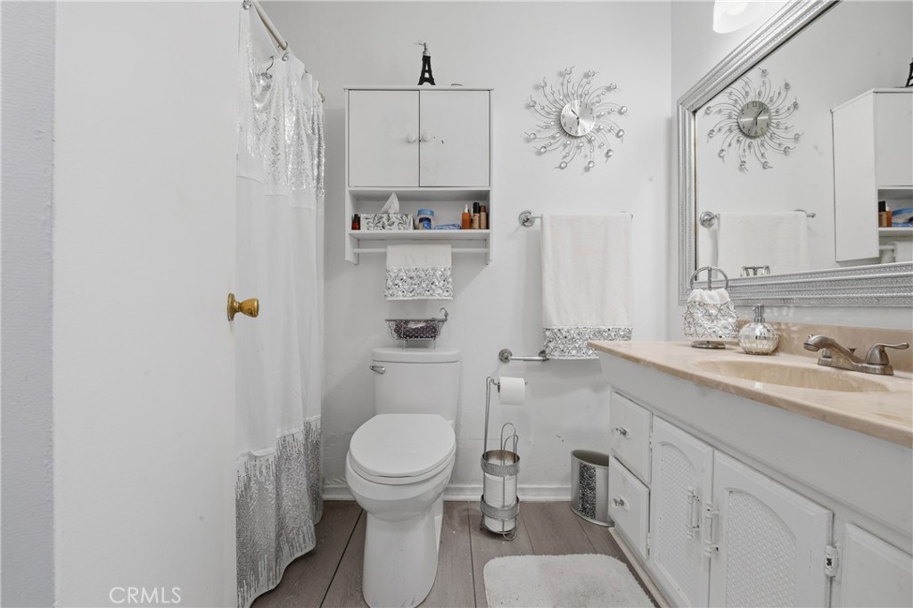 645 West Winchester Drive Rialto, CA 92376 - Photo 18 of 22 a bathroom with a toilet sink a shower and a mirror