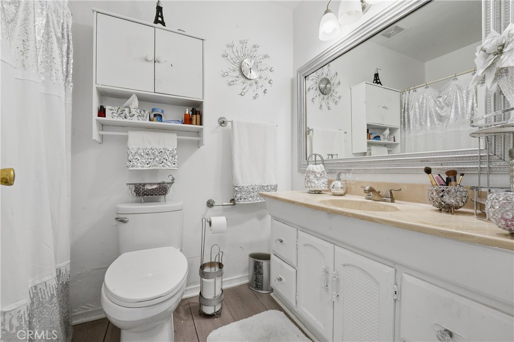 645 West Winchester Drive Rialto, CA 92376 - Photo 19 of 22 a bathroom with a granite countertop toilet sink and a mirror