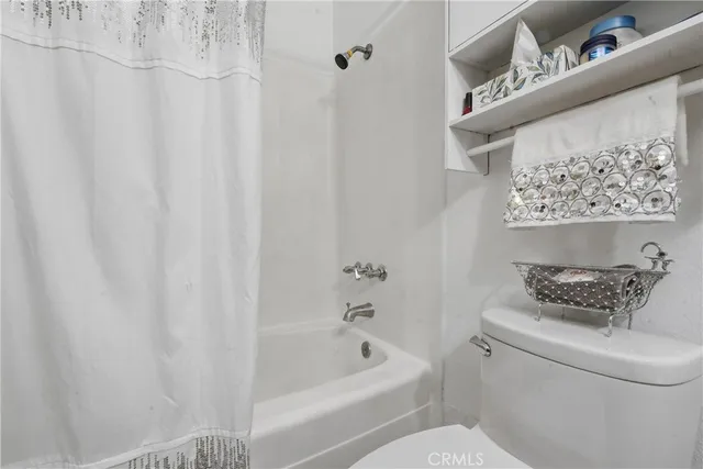 a bathroom with a toilet and a bathtub