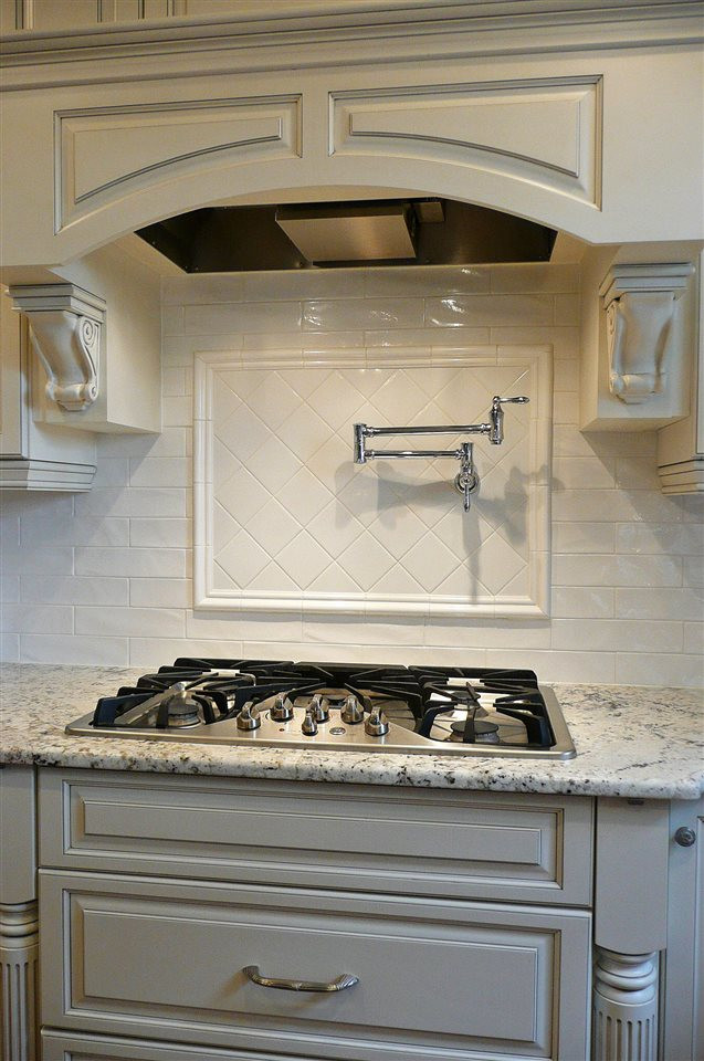 4905 Gable Ridge Lane Holly Springs, NC 27540 - Photo 4 of 25 This kitchen has all the bells and whistles included. The gas cooktop and pot filler will certainly please the chef in the family. There are two built-in spice racks, one on each side of the cooktop, and both under cabinet and pendant lighting. Many Bells & Whistles