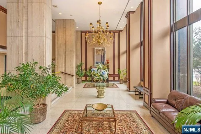 a living room with patio furniture and a potted plant