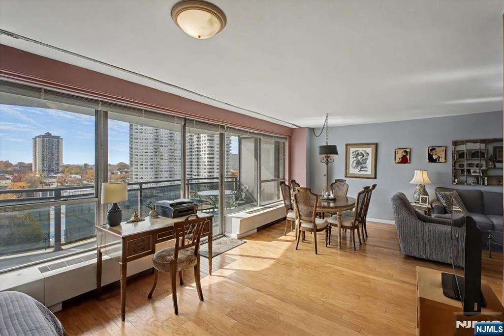 2077 Center Street, Unit 9B Fort Lee, NJ 07024 - Photo 5 of 17 a living room with furniture and a floor to ceiling window