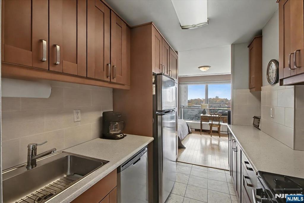 2077 Center Street, Unit 9B Fort Lee, NJ 07024 - Photo 7 of 17 a kitchen with a sink cabinets and appliances
