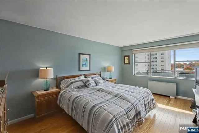 a bedroom with a large bed and a large window