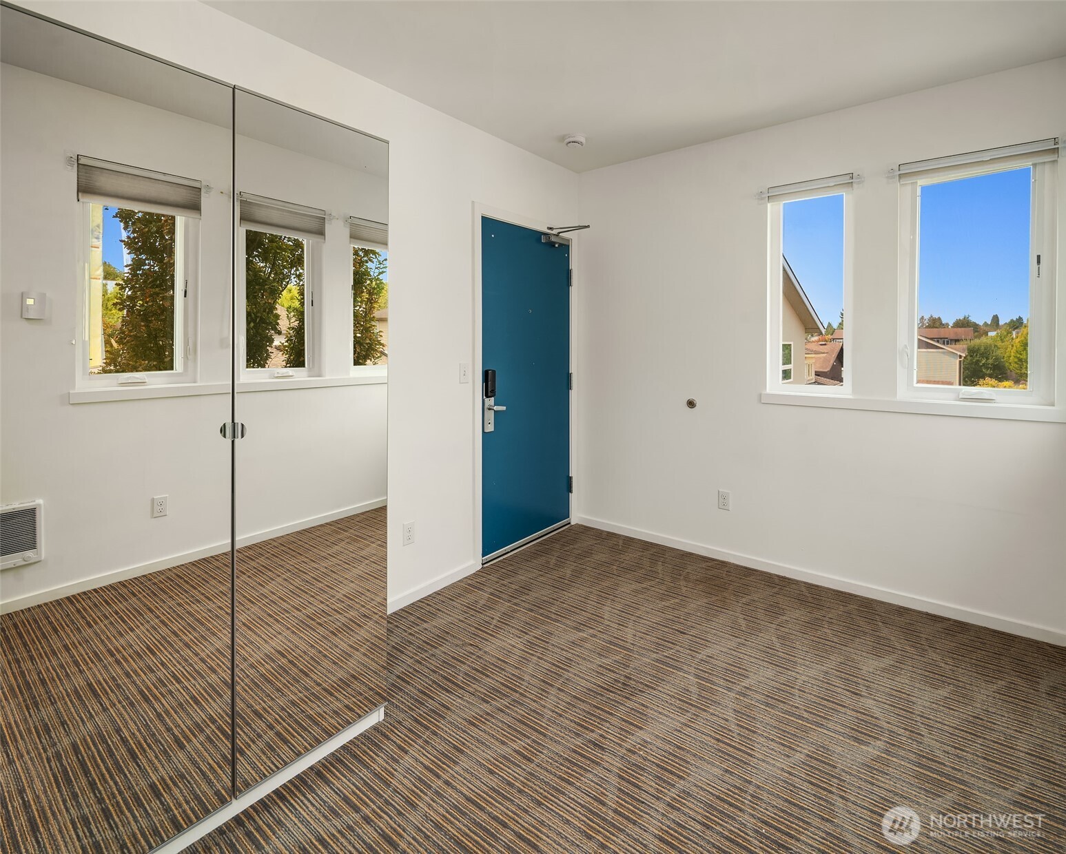 2418 Northwest 58th Street Seattle, WA 98107 - Photo 3 of 6 a view of an empty room with window and wooden floor