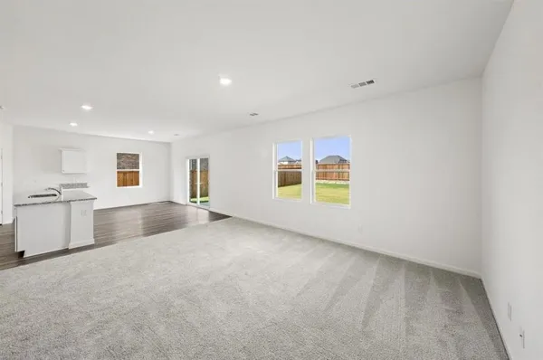 an empty room with a kitchen and a sink