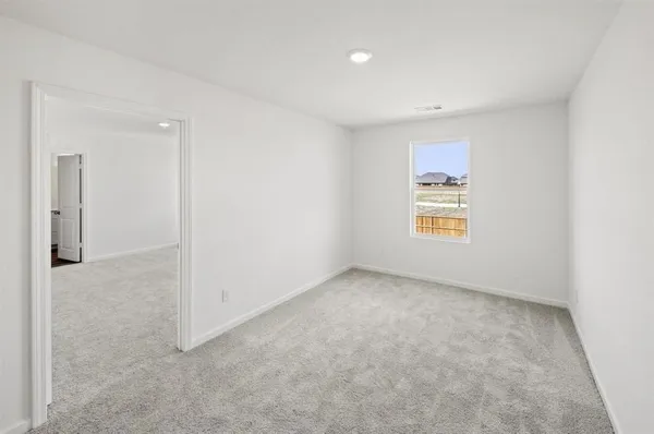 an empty room with windows and closet