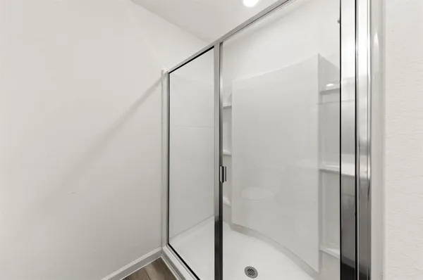 a bathroom with a glass shower door