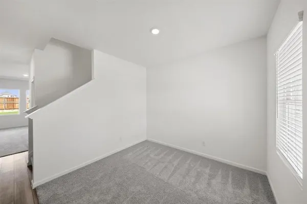 a kitchen with kitchen island a sink stainless steel appliances and white cabinets