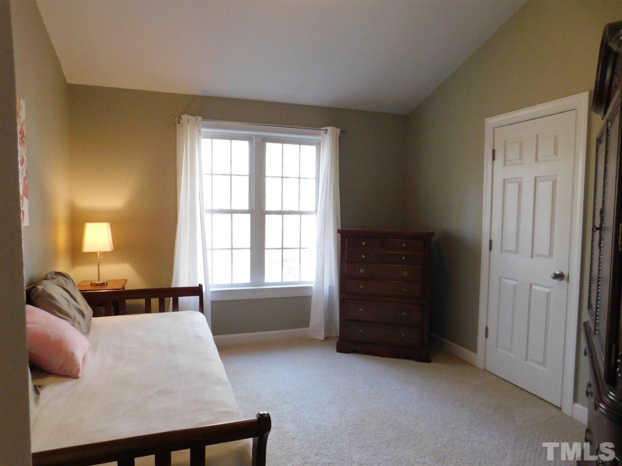 9247 Shallcross Way Raleigh, NC 27617 - Photo 14 of 25 a bedroom with a bed and a couch