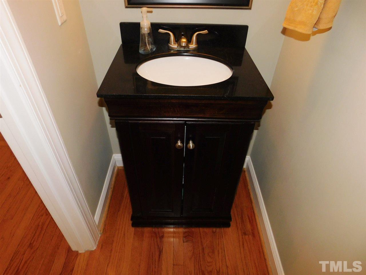 9247 Shallcross Way Raleigh, NC 27617 - Photo 8 of 25 a bathroom with a sink and a mirror