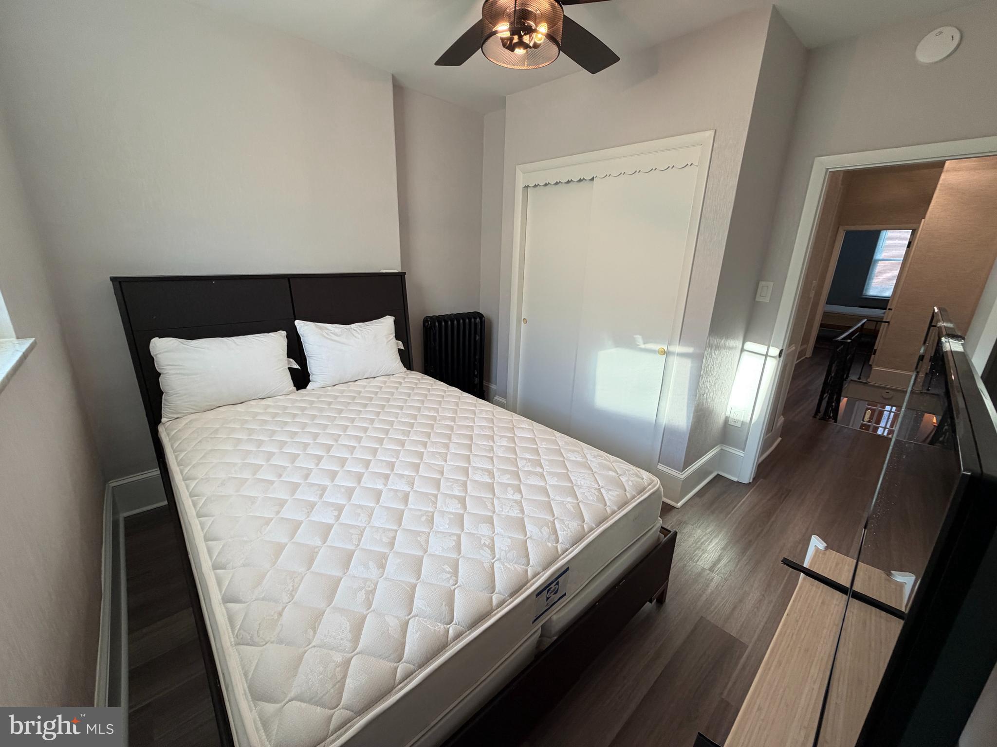 1946 Fitzgerald Street Philadelphia, PA 19145 - Photo 12 of 18 a bedroom with a bed and a chandelier