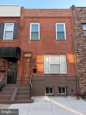 a front view of a building with parking area