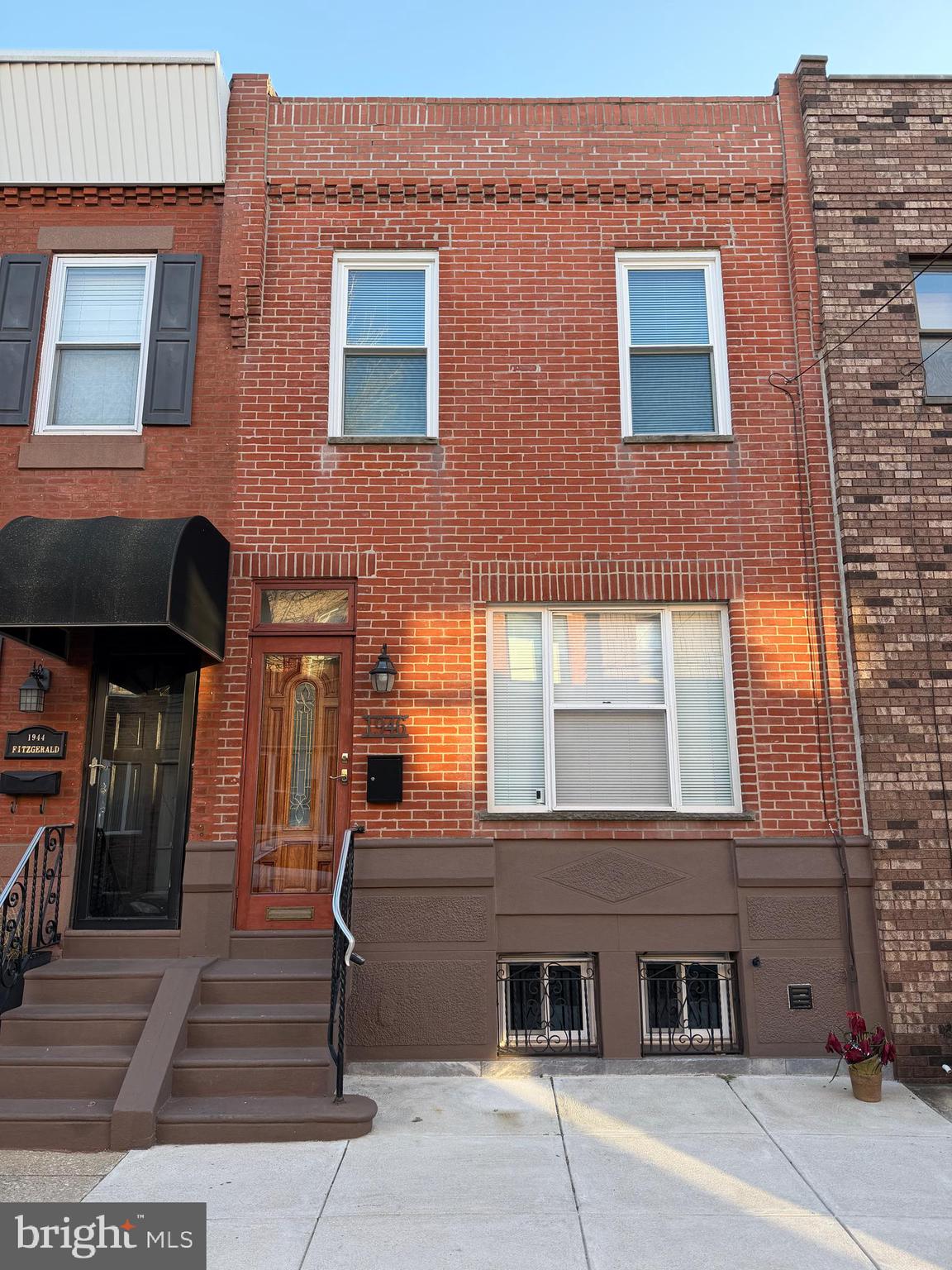 1946 Fitzgerald Street Philadelphia, PA 19145 - Photo 17 of 18 a front view of a building with parking area