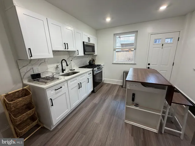a kitchen with a sink stove and cabinets