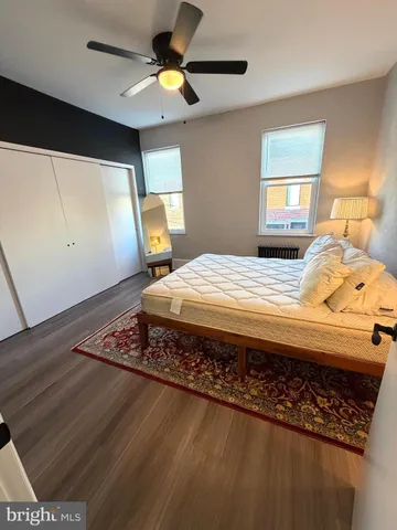 a bedroom with a bed dresser and a window