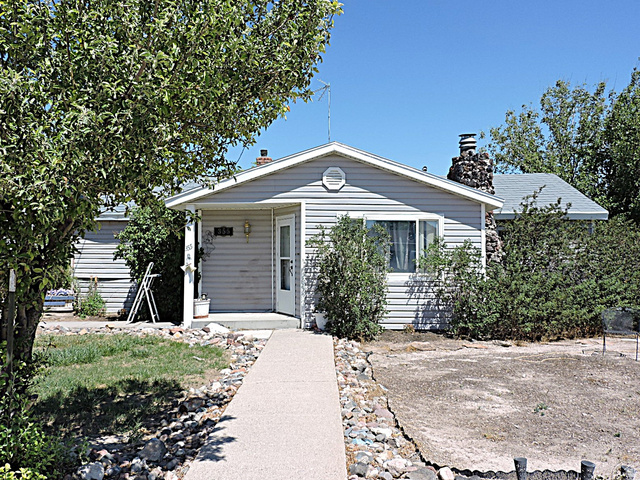 355 South Center Street Delta, UT 84624 - Photo 1 of 21 Ranch-style residence featuring light gray siding and a stone chimney