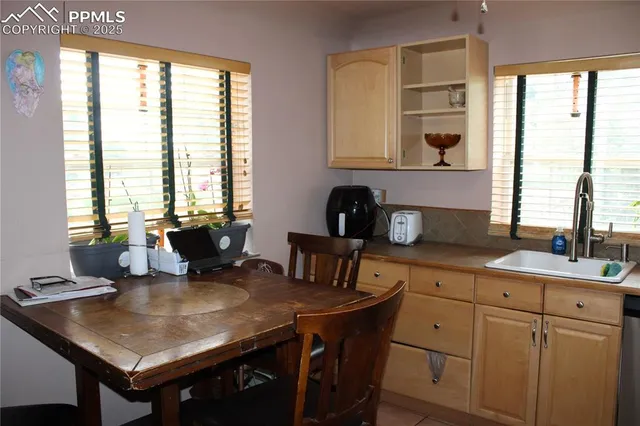 a kitchen with stainless steel appliances granite countertop a refrigerator a stove and a sink