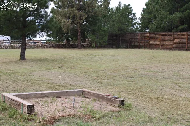 a backyard of a house with lots of green space and lake view