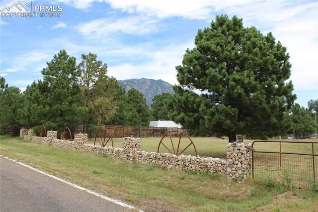 a view of a chairs and table in the back yard of the house