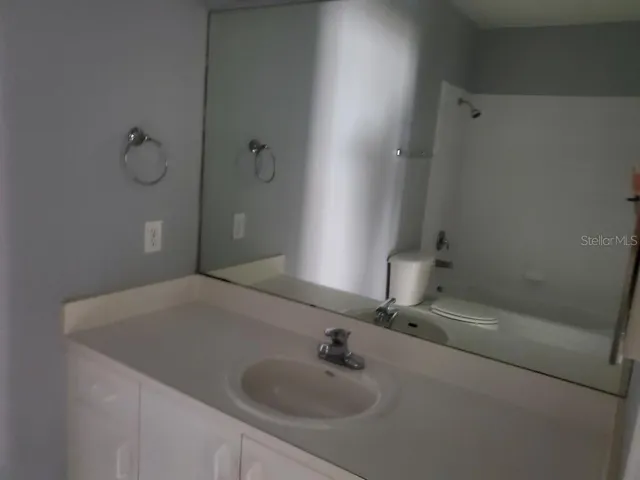 a bathroom with a sink and shower