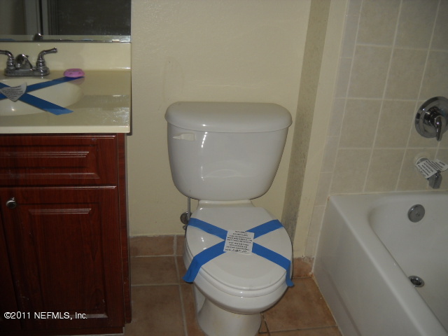 9745 Touchton Road, Unit 2403 Jacksonville, FL 32246 - Photo 5 of 9 a bathroom with a toilet and a sink