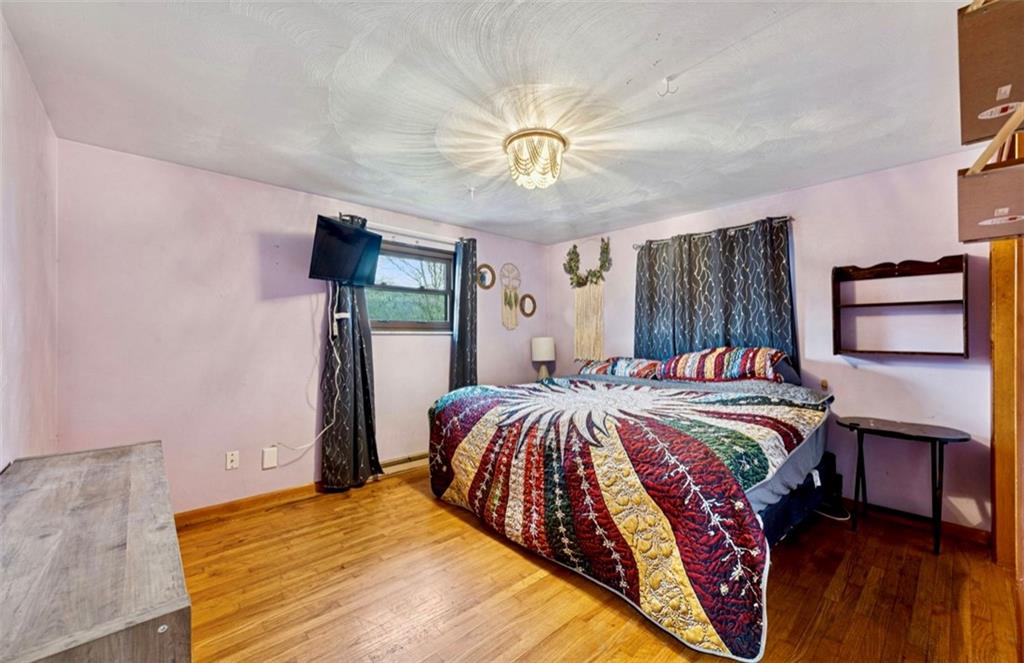 501 Highway 356 Apollo, PA 15613 - Photo 15 of 35 a bedroom with a bed and a chandelier