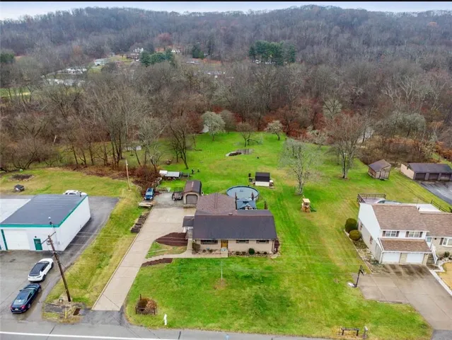 an aerial view of a house with yard swimming pool and outdoor seating