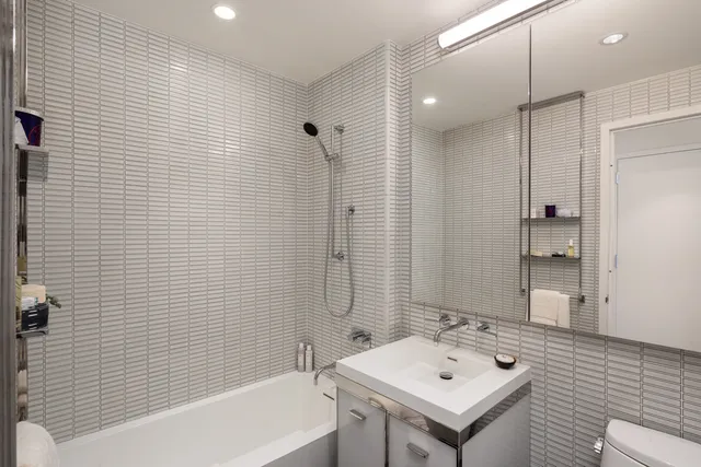 a bathroom with a double sink shower and a mirror